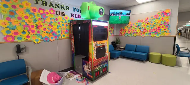 Photo booth beside a wall of thank-you notes, June 2023