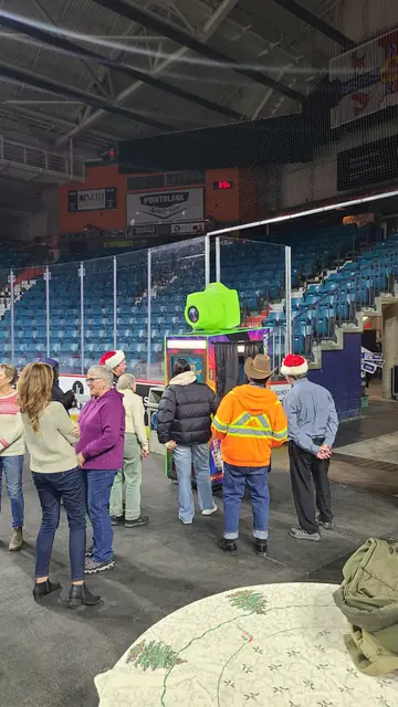 Guests lining up for the photo booth at an arena event, December 2023