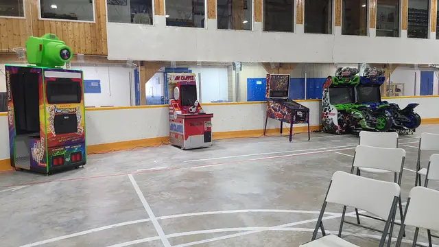 Photo booth in a hall next to arcade games, June 2024