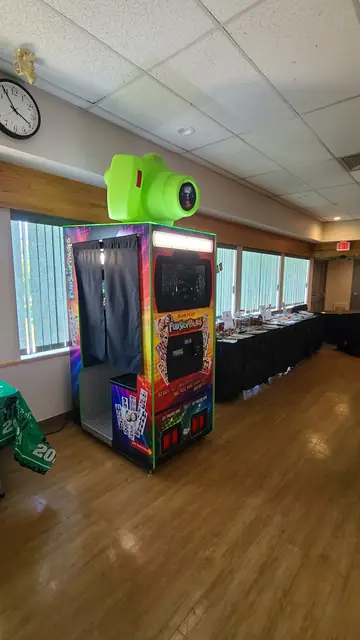 Photo booth in a hall with wood floors and large windows, June 2024