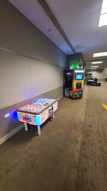 Photo booth at the end of a hallway with an air hockey table, October 2024