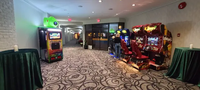 Photo booth in a ballroom alongside arcade racing simulators, November 2024