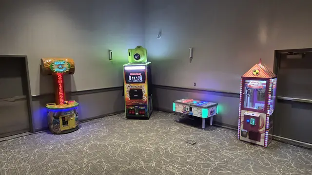 Photo booth set up with arcade games in the same room, February 2026