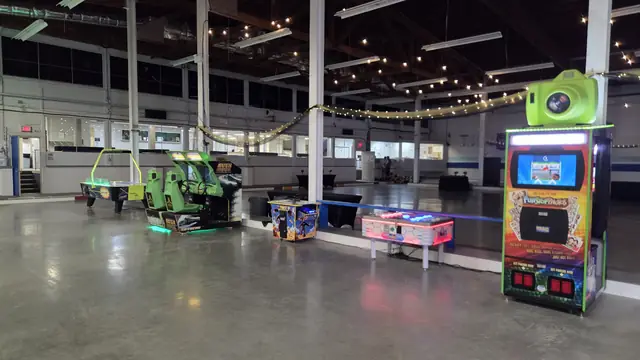 Photo booth in a large open venue with arcade games, June 2026